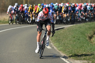 Matt attacking from the peloton during the 2022 Paris-Nice, while wearing the KOM jersey