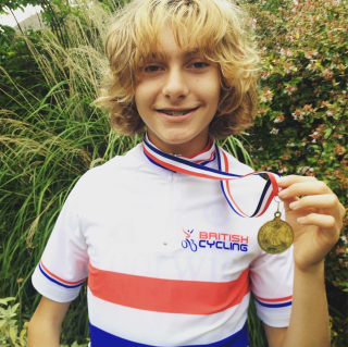 A young Matthew Robertson with British National champ jersey holding a medal